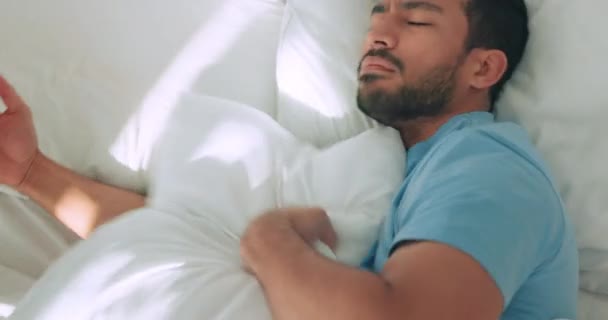 Insomnia, sleep and sleepless man in bed with anxiety, depression or pain. Stress, depressed or male with poor sleeping habits unable to fall asleep, rest or snooze, nap or close eyes from above - Záběry, video