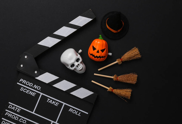 Horror movie, halloween concept. Movie clapperboard with halloween decor on black background - Fotografie, Obrázek