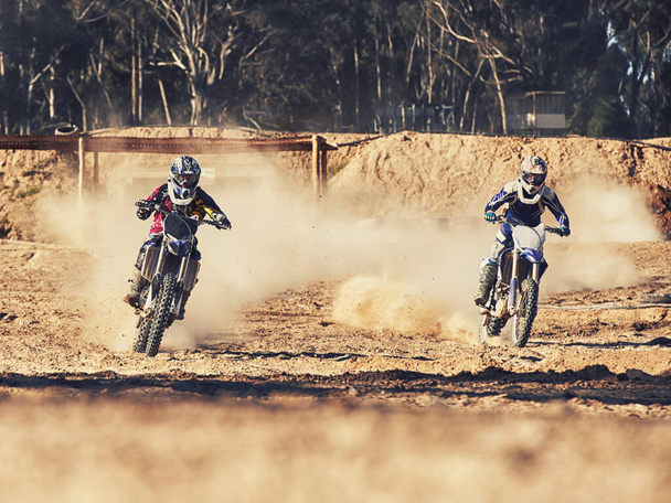 Time to rip up this track. two motocross racers speeding along the track - Fotografie, Obrázek