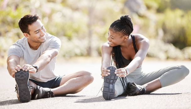 Sport, fitness and exercise with a sports man and woman training and stretching during an outdoor workout. Health, wellness and motivation with an athlete couple or personal trainer ready to start. - Photo, Image