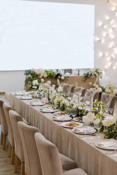 Tables setting at a luxury wedding. Table for guests. Dishes and drinks. Wedding table preparation.  - Photo, image
