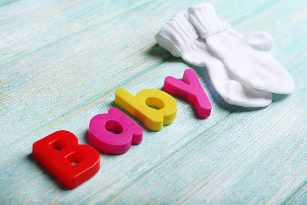 Baby word formed with colorful letters on wooden background - Foto, Imagem