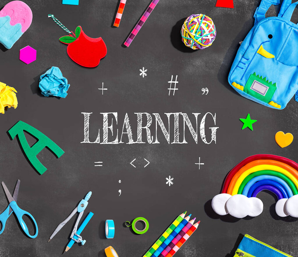 Learning concept with school supplies on a chalkboard - flat lay - Photo, image