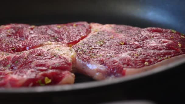Bloody beef entrecote is fried in a pan. - Footage, Video