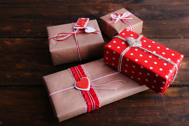 Three gift boxes on wooden background - 写真・画像