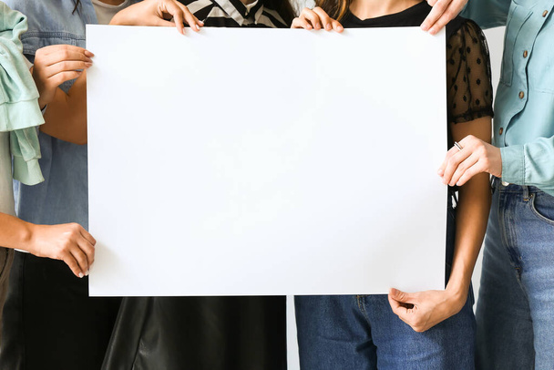 Women with blank paper sheet on white background, closeup - Photo, Image