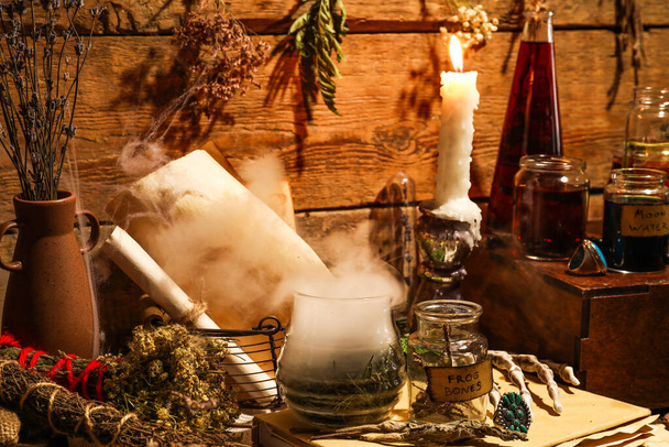 Ingredients for witch's ritual and burning candle on wooden background - Photo, Image