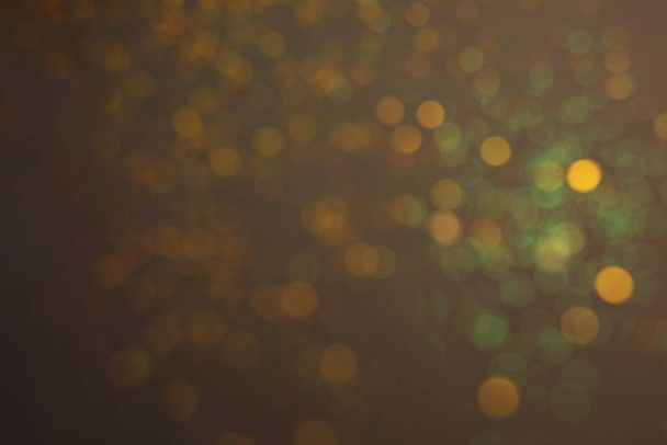 Blurred view of festive lights on grey background. Bokeh effect - Foto, imagen