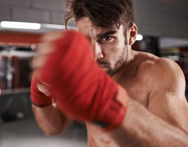 Kickboxing is his life. a handsome young kickboxer in the gym - Foto, Imagem