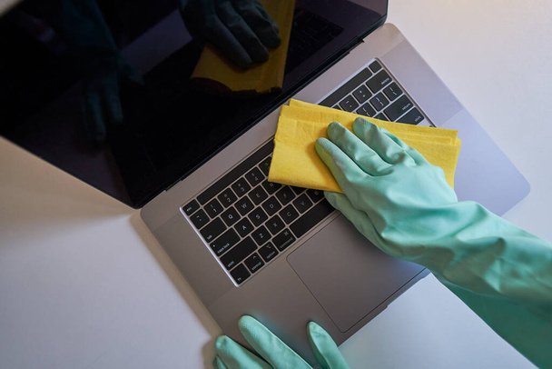 Disinfecting laptop. cleaning laptop at home. cleaning laptop in the office. wiping laptop keyboard - Fotografie, Obrázek