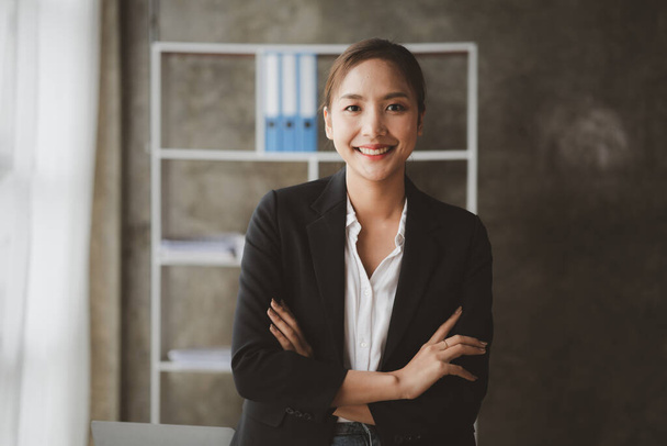 Portrait of a young beautiful Asian woman in a office room, concept image of Asian business woman, modern female executive, startup business woman, business leader woman. - Фото, изображение