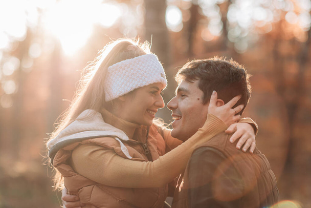 Young, romantic couple looking in love in the woods. Autumn time - Foto, immagini