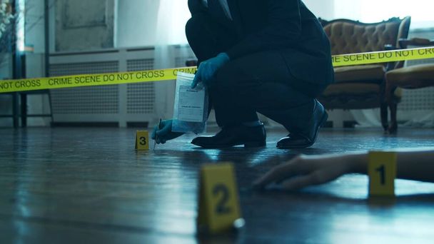 Detective Collecting Evidence in a Crime Scene. Forensic Specialists Making Expertise at Home of a Dead Person. The Concept of Homicide Investigation by Professional Police Officer. - Photo, Image