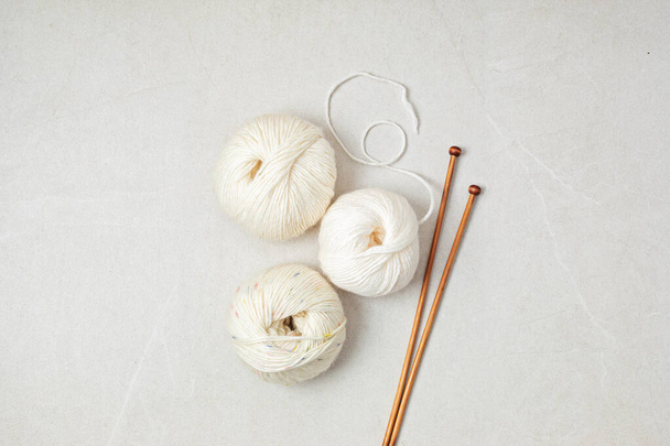 Craft hobby background with yarn in natural colors. Recomforting hobby to reduce stress for cold fall and winter weather. Mock up, copy space, top view - Photo, image