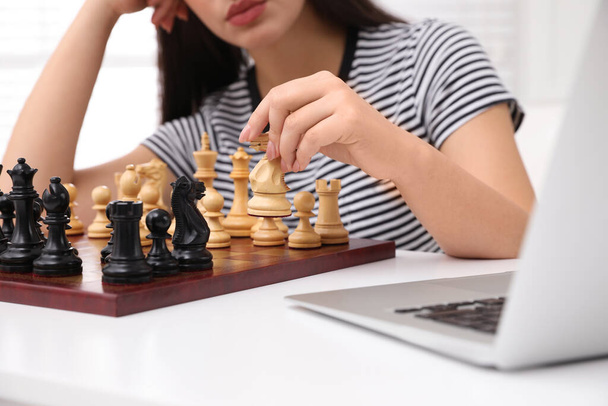 Woman playing chess with partner through online video chat at home, closeup - Photo, image