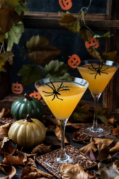 Orange Halloween cocktail and holiday pumpkin on  dark mystical autumn background, selective focus with shallow depth of field - Foto, Imagem