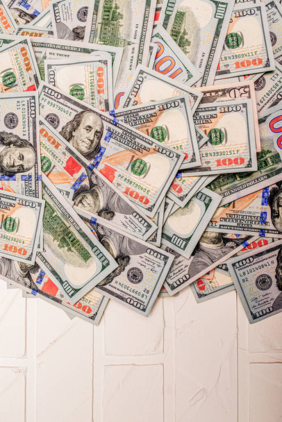 アメリカ通貨の金融概念。白いレンガの背景にあるお金のドル. - 写真・画像