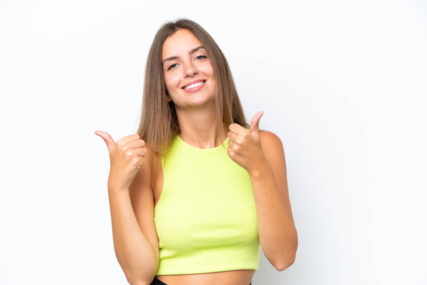 Young caucasian woman isolated on white background with thumbs up gesture and smiling - Photo, Image