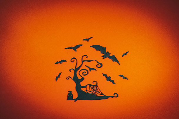 Halloween black carved tree with flying bats on the orange background.. - Photo, Image