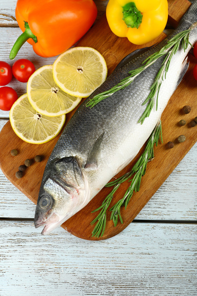Fresh raw fish and food ingredients on table - Photo, Image