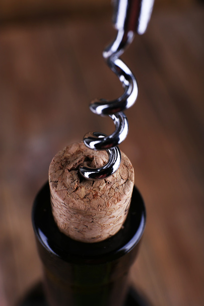 Bottle opener close-up, on wooden background - Φωτογραφία, εικόνα