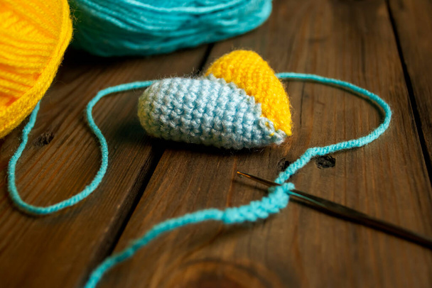 The heart is crocheted with two colors. The heart is yellow-blue. Colors of the flag of Ukraine. knitting a two-tone heart. Patriotic heart of two colored crochet. - Photo, Image