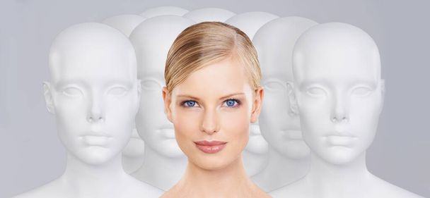 Bring your beauty to life. A young woman standing amongst a group of mannequins - Foto, Bild