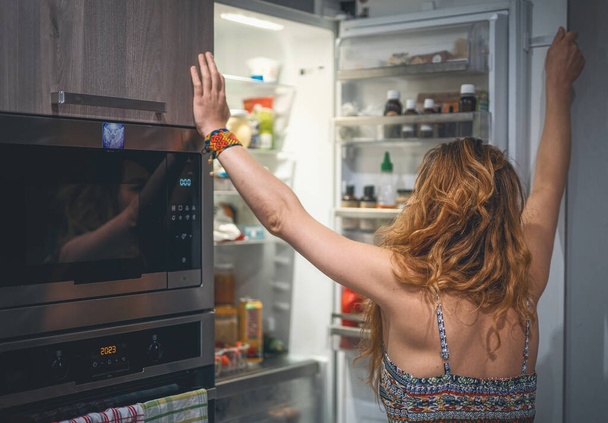 woman in front of the refrigerator - 写真・画像