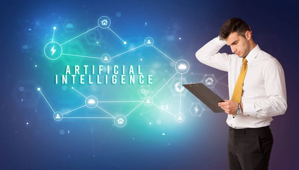 Businessman in front of cloud service icons with ARTIFICIAL INTELLIGENCE inscription, modern technology concept - Photo, image