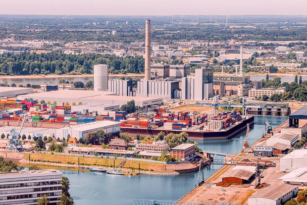 An industrial port with cargo containers and factory pipes in the suburbs of Dusseldorf on the banks of the Rhine River - Photo, Image