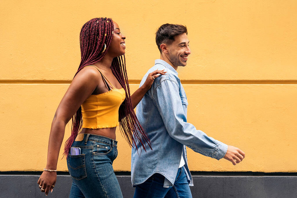 Cute young couple wearing casual clothes having fun in the streets of Madrid and walking. - Fotoğraf, Görsel