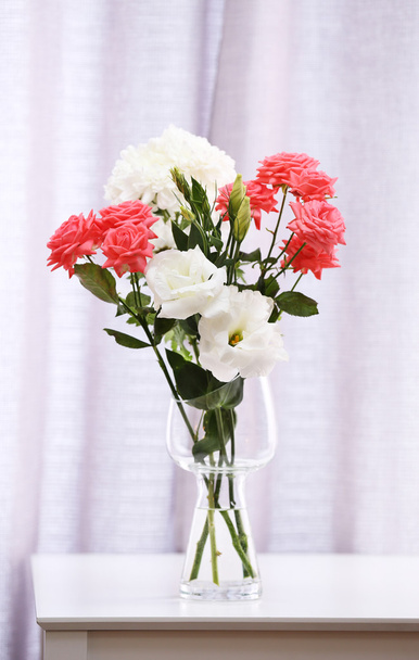 Beautiful flowers in vase on curtains background - Foto, Imagen