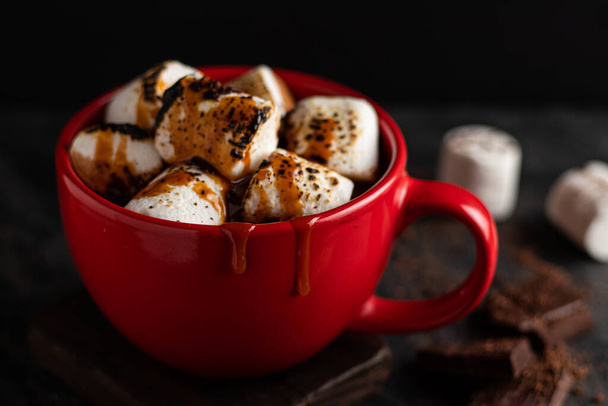 xícara de chocolate quente com marshmallows e biscoitos na mesa escura - Foto, Imagem