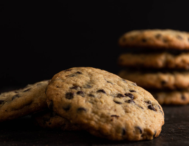 homemade cookies with chocolate glaze on a dark background. selective focus. - Foto, imagen
