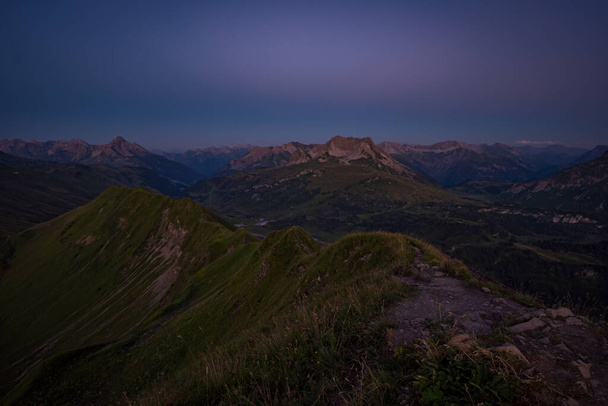 Beautiful sunset hiking from the top in the mountains while hiking in Vorarlberg, Austria - Fotó, kép