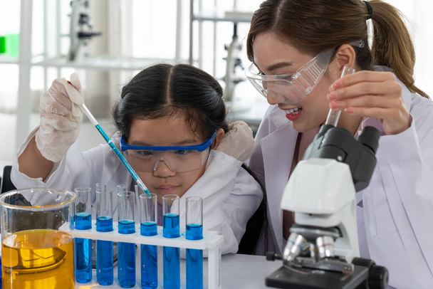 Los niños asiáticos aprenden química y ciencia en laboratorio con el profesor - Foto, Imagen
