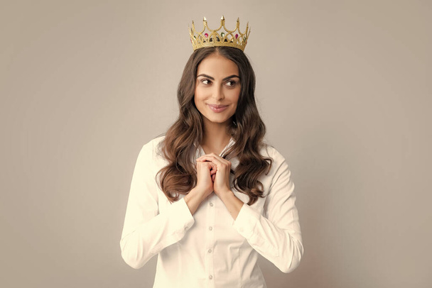 Proud arrogant woman with gold crown. Happy woman in crown, self confident queen, princess in diadem tiara. Selfishness concept - Фото, изображение