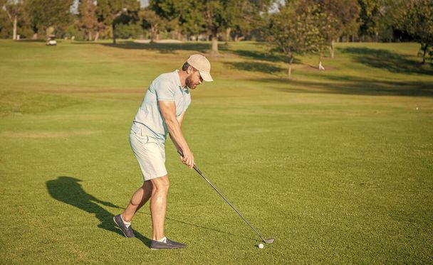 golfer full length in cap with golf club, summer. - Zdjęcie, obraz