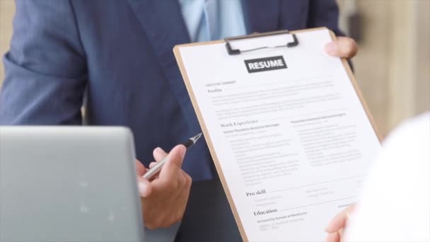 The manager is interviewing job applicants and reading the candidate's personal information on the resume. The idea of recruiting to recruit people to work in the missing position. - Footage, Video
