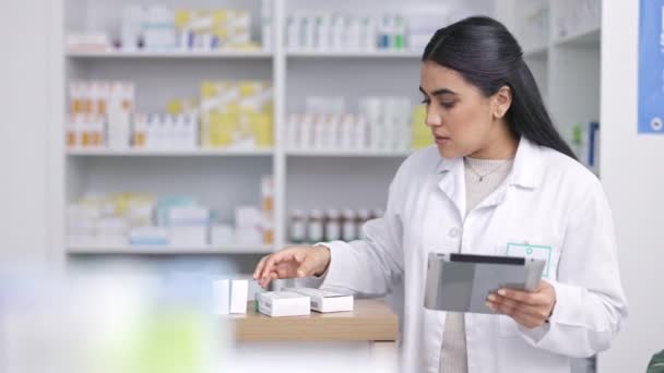 Pharmacist, healthcare and medicine with a woman nurse filling an online order with a tablet in the pharmacy. Medical, pills and insurance with a female health professional working in a drugstore. - Filmagem, Vídeo