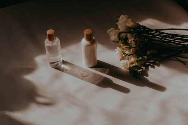 Bottles with cosmetics, moisturizing cream and gel on the table. - Φωτογραφία, εικόνα