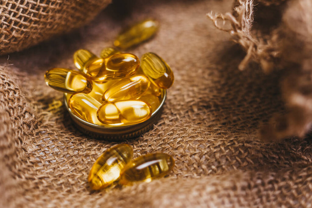 Fish oil capsules. Vitamin complex omega 3,6,9. Fish oil capsules with omega-3, vitamin D. Copy space - Photo, Image