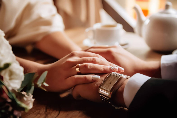 Hands of newlyweds with rings. Tender feelings of lovers. High quality photo - Photo, Image