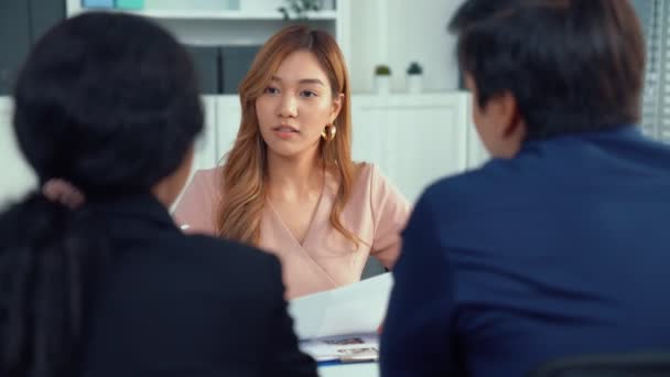 A young female asian candidate tries to impress her interviewer by being competent. International company, multicultural environment in workplace. - Video, Çekim