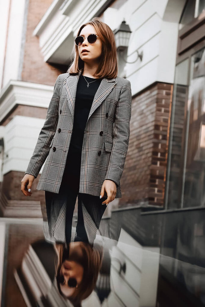 A girl in a business suit in the old town with glasses - Photo, image