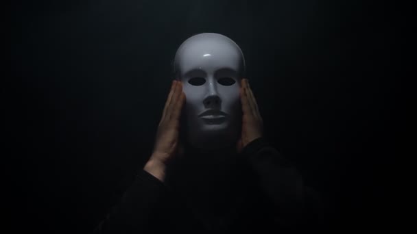 Man in a hoodie takes off his mask. - Footage, Video