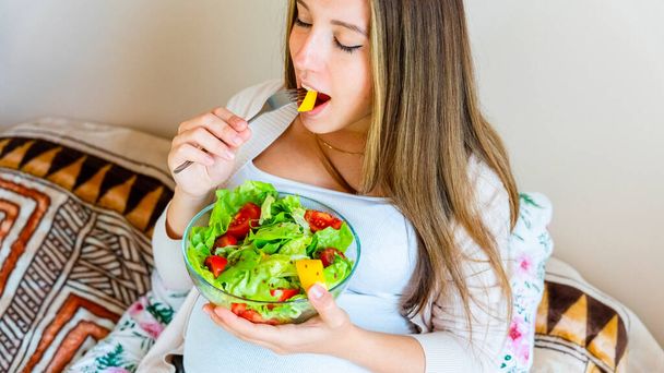 Pregnant woman eating healthy food. Happy pregnancy mother eating nutrition diet salad. Healthy breakfast food concept - Photo, Image
