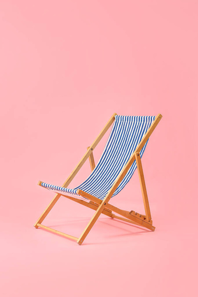 Beach deck chair on pink background - Foto, imagen