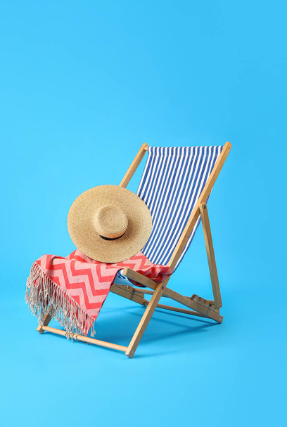 Deck chair and beach accessories on light blue background - Photo, Image