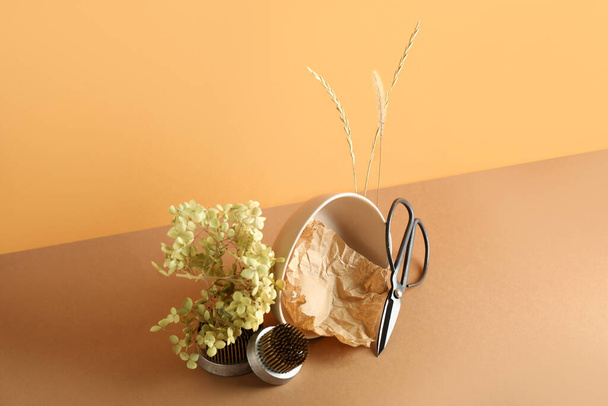 Миска з папером, ножицями, колосками, гілкою рослин та кецанами для ікебани на кольоровому фоні
 - Фото, зображення